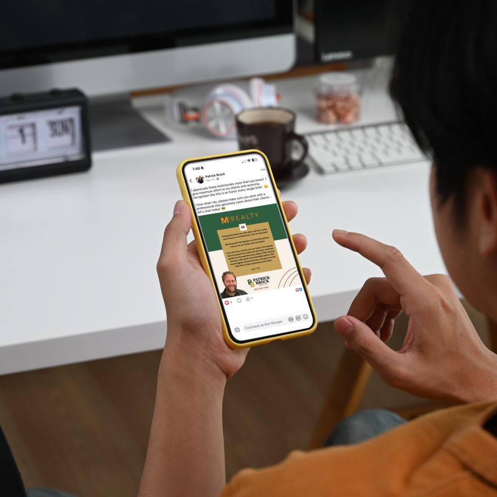 Person viewing a Facebook testimonial post from Patrick Brock, realtor with M Realty, on a smartphone in a yellow case.