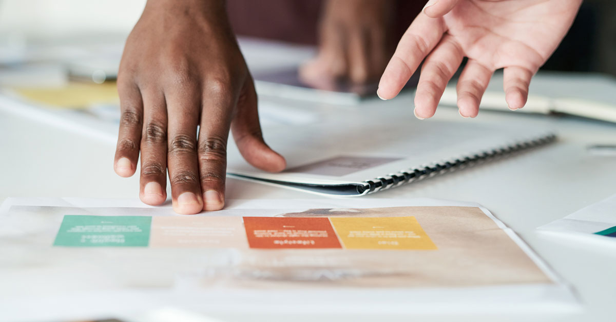 Two people reviewing a small business brand guide