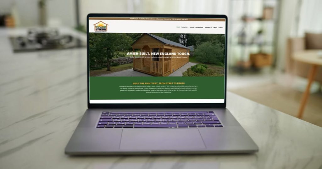 A computer monitor displaying the Amish Sheds website