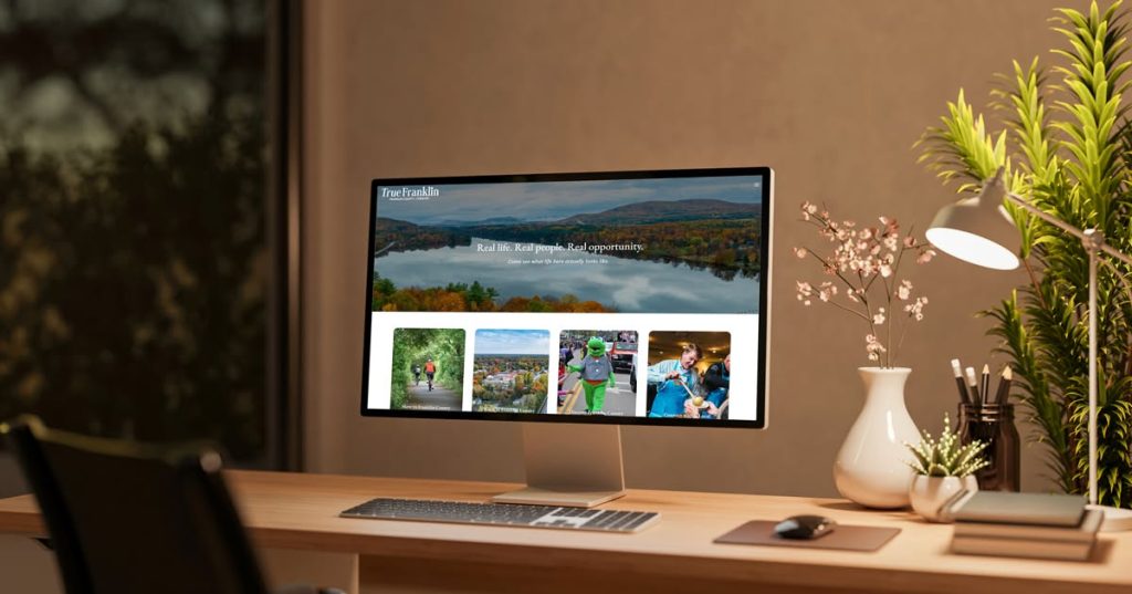 A computer monitor displaying the True Franklin website