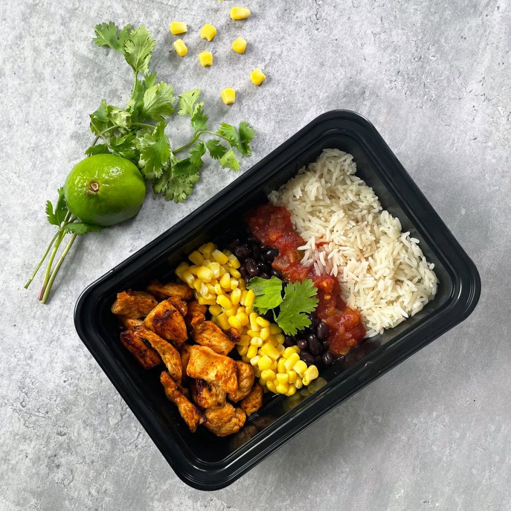 Overhead view of a prepared chicken fajita meal in a black container