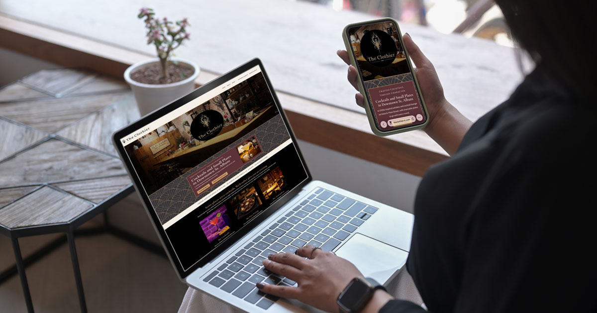 Woman on a laptop and phone, both displaying The Clothier Website
